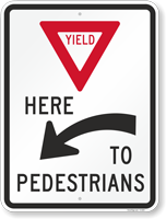 Yield Here To Pedestrians Arrow Sign